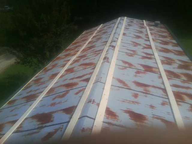 Rusted metal roof panels with new wood purlins before replacement — Storm Damage Roof Repair in Rosendale by Roofing Brothers