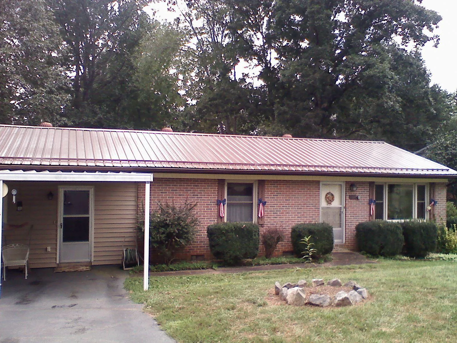 Bronze metal roof and carport on a brick ranch home — Roof Repair work by our crew in Rosendale